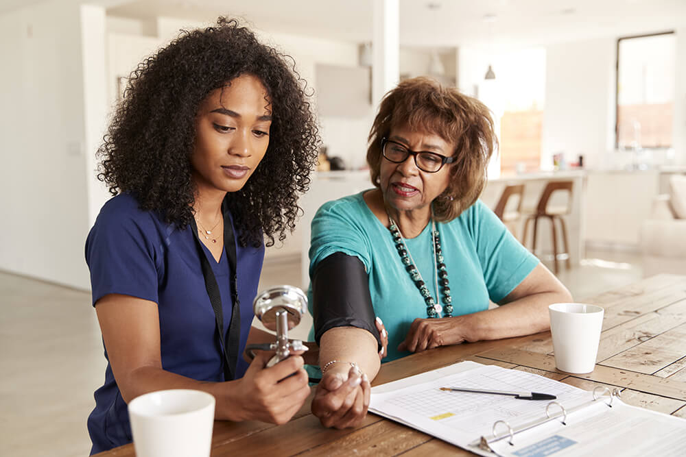 Nurse checks blood pressure of patient